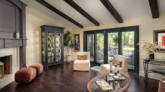 Clarita living room remodel with dark wood floors, exposed ceiling beams and black-framed doors