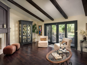 Clarita living room remodel with dark wood floors, exposed ceiling beams and black-framed doors
