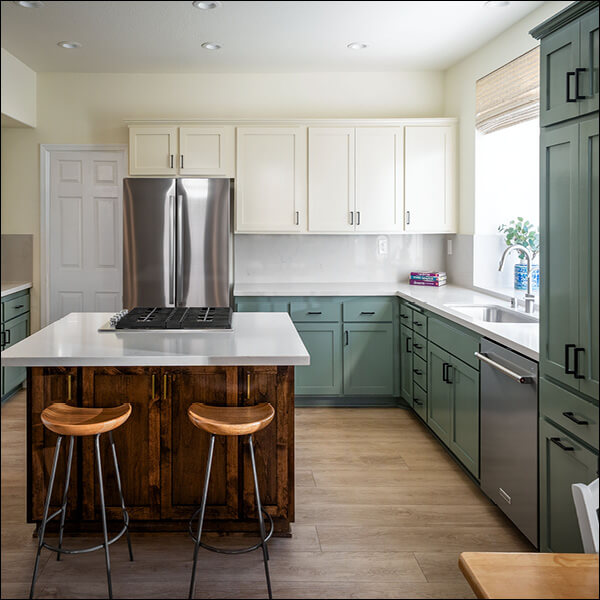 After: Bright, updated kitchen with improved storage, a spacious island, and contrasting finishes