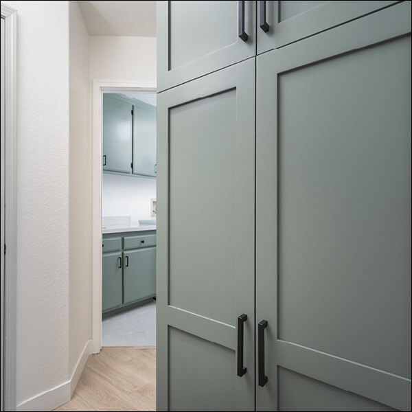 After: Floor-to-ceiling custom cabinetry provides concealed storage near the garage entry